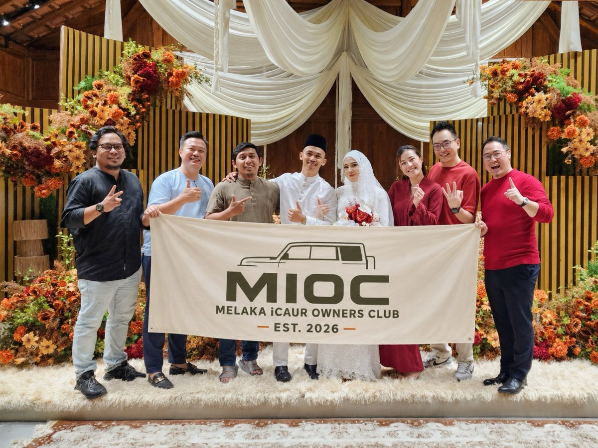 MIOC group photo with banner